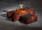 Macallan 72 Years Old in its Clive Christian oak presentation cabinet with Lalique decanter